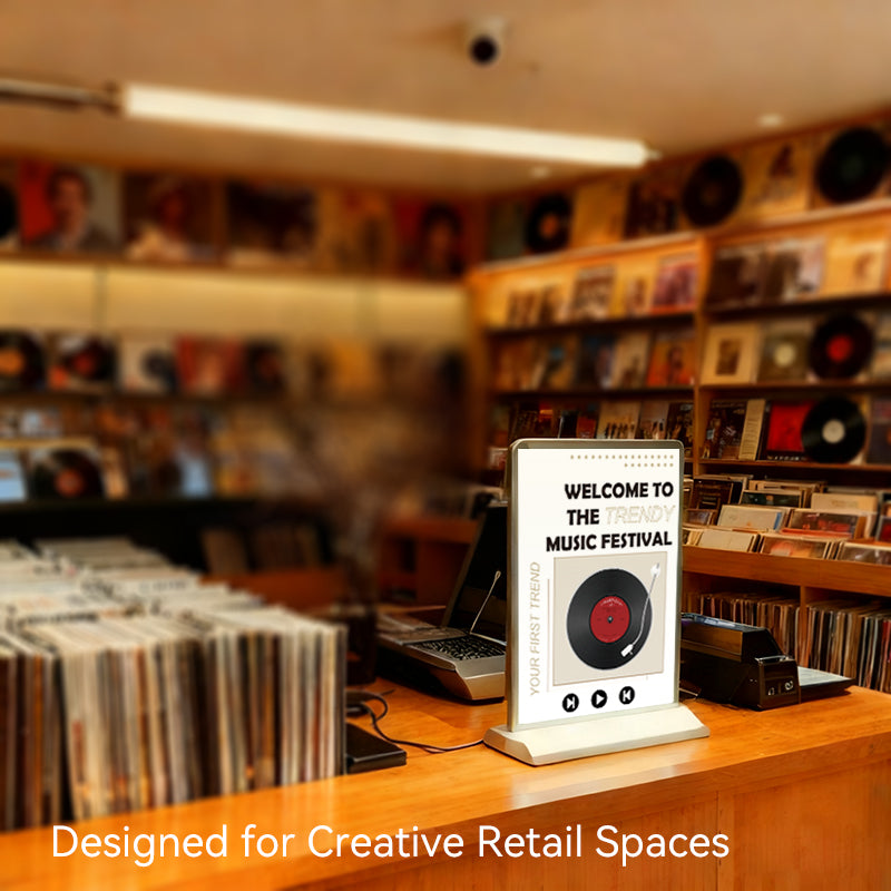 portable rechargeable LED light box on office desktop with promotional poster
