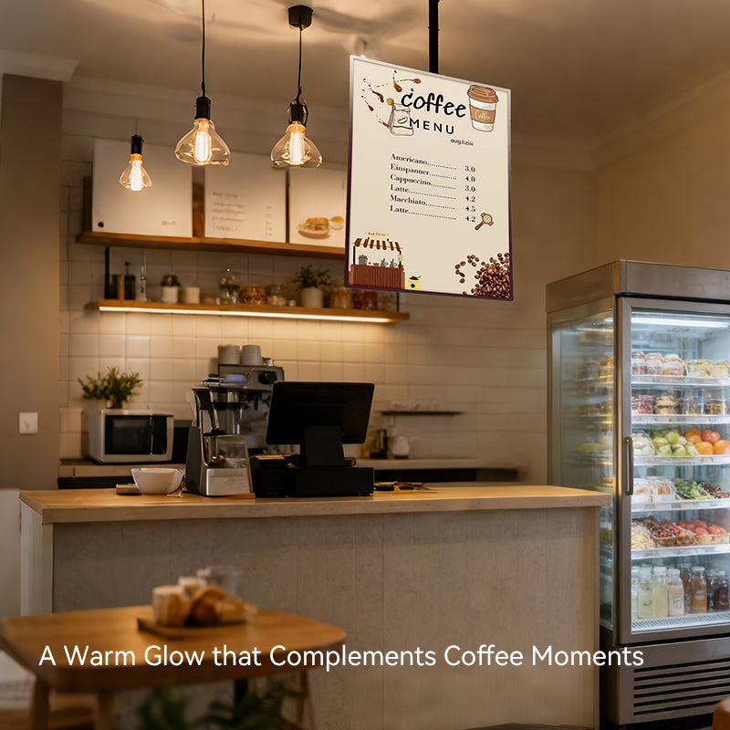 coffee shop interior with a counter, menu board, and refrigerator.